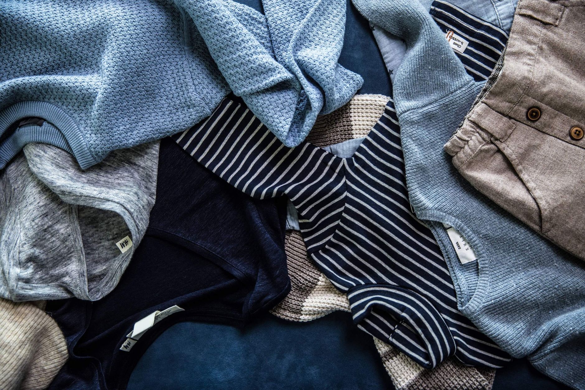 flat lay of children s casual clothing on blue background